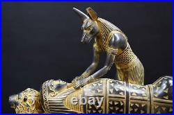 Egyptian god Anubis, the god of mummification, mummify King Tutankhamun