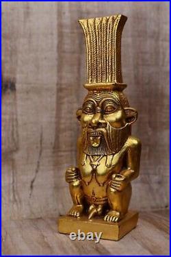 Great statue of god Bes, god protector of households stone covered by gold leaf