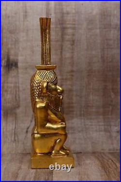 Great statue of god Bes, god protector of households stone covered by gold leaf