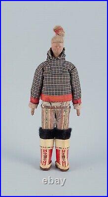 Greenlandica. Woman wearing Greenlandic dress. Made of wood and fabric