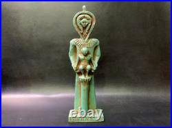 In a perfect scene HATHOR goddess standing as man and taking care of Horus