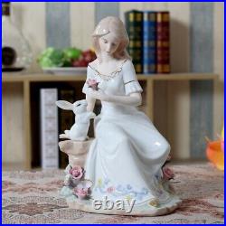 Porcelain Figurine Of A Lady In The Garden Holding A Pink Flower With A Rabbit