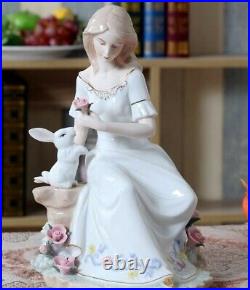 Porcelain Figurine Of A Lady In The Garden Holding A Pink Flower With A Rabbit